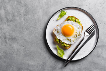 Wall Mural - Avocado toast with fried egg