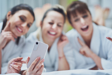 Girls at spa party in hotel with phone