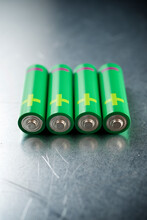 Close-up Of Green Batteries On Table