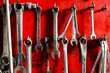 pliers hanging on a nail on the red wall,Repair Tools.