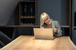 © Srdjan - Young business frustrated woman annoyed and angry because bank canceled her credit card due to exceeding the allowed limit and minus on the bank account she can't buy and pay online on laptop