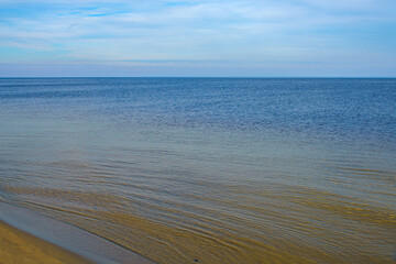 Wall Mural - Natural background, sandy shore and water.