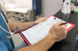 © Austockphoto - Close up shot of a medical form filled up by a health care personnel in the clinic