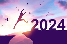 Silhouette Man Jumping Between Cliff To 2024 And Birds Flying At Top Of Mountain. Freedom Challenge And Travel Adventure Holiday Concept.