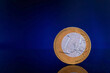 One euro coin on dark blue background. Concept, closeup