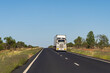 A large transport truck travelling on a wide outback road - road train