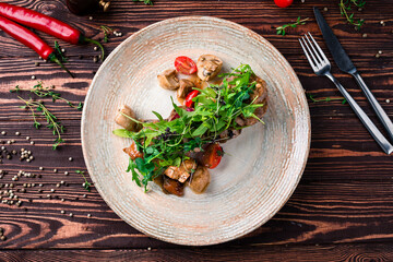 Sticker - Veal medallions with mushrooms, arugula, cherry tomatoes and sauce.