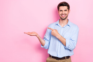 Sticker - Photo of positive man arm demonstrate empty space special deal super product sale discount isolated on pink color background