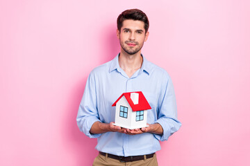 Sticker - Photo of confident real estate manager realtor hold miniature building new apartments for sale cheap price offer isolated on pink color background