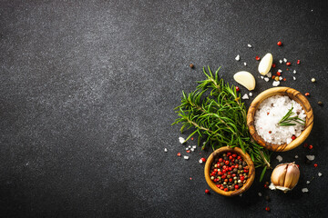 Wall Mural - Ingredients for cooking on black stone kitchen table. Herbs, spices and vegetables. Flat lay.