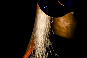 Wall Mural - Grinding the surface of the part shaft on a cylindrical grinding machine.