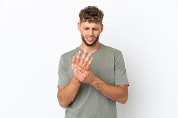 Wall Mural - Young caucasian handsome man isolated on white background suffering from pain in hands