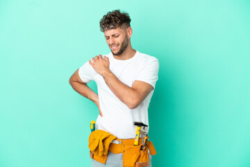 Wall Mural - Young electrician blonde man isolated on green background suffering from pain in shoulder for having made an effort