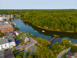Newmarket Mills building aerial view on Lamprey River on Main Street in historic town center of Newmarket, New Hampshire NH, USA. Now this building is Rivermoor Landing Apartment.