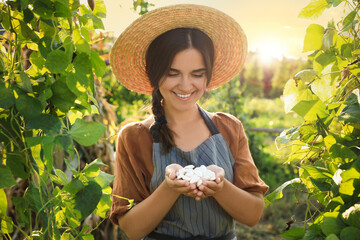 Canvas Print - Woman holding white beans in hands outdoors