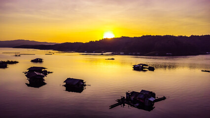 Wall Mural - Aerial view of landscape sunset with Reservoir and raft house Thailand