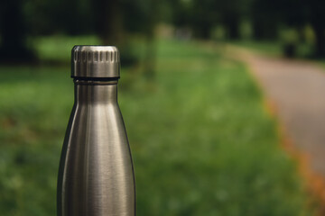 Wall Mural - Water bottle. Reusable steel thermo water bottle on green grass. Sustainable lifestyle. Plastic free zero waste free living. Go green Environment protection. Health-conscious. Steel thermo water