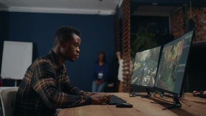 video game development company, african american man creating 3D graphics by powerful computer