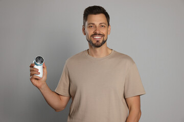 Poster - Handsome man holding fabric shaver on light grey background