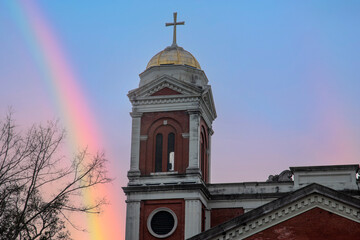 Wall Mural - the bell tower at Cathedral-Basilica of the Immaculate Conception with blue sky and a rainbow in Mobile Alabama USA