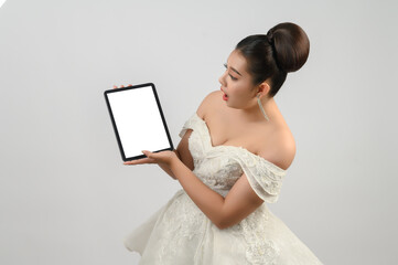 Young asian beautiful bride pose with tablet in hand