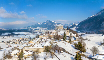 Aerial image of the medieval town Gruyeres with Castle on the hill top of Alps in winter. It is one of the most popular tourist destionations.