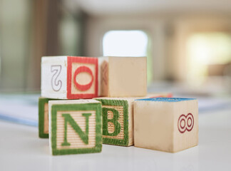 Wooden blocks, table and letters for learning, education or childhood development at home. Colorful wood cube toys to learn numbers or alphabet for back to school, spelling or mathematics to read