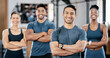 © J Maas/peopleimages.com - Fitness, portrait and man personal trainer with clients standing with crossed arms in the gym. Sports, collaboration and happy people after exercise, workout or training class in sport studio.