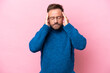Middle age caucasian man isolated on pink background with headache