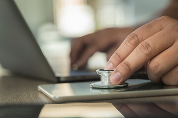 Wall Mural - stethoscope computer and background doctor using laptop at desk medical network on Computing electronic medical