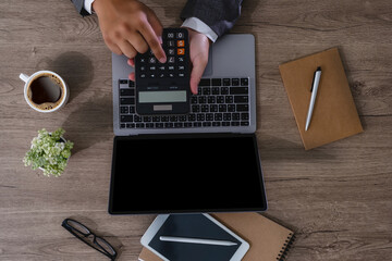 Wall Mural - businessman using a calculator top view, calculating user expenses, budgeting, and loan accounting 