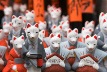 Miniature Fox Statues At The Fushimi Inari Shrine,  Kyoto, Japan