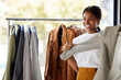 © Joshua A/peopleimages.com - Shopping, clothes and black woman for choice, wardrobe inspiration or retail design ideas in thrift store or boutique. Happy customer, student or person service in fashion discount, sale or promotion