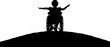 Silhouette of a happy disabled child girl sitting in a wheelchair atop a hill. Vector Silhouette