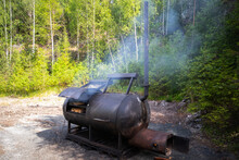 Huge Wood Smoker Stands On The Edge Of The Forest On A Sunny Day