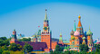 Spasskaya Tower of Moscow Kremlin and Cathedral of Vasily the Blessed (Saint Basil's Cathedral) on Red Square in sunny summer day. Panorama. Moscow. Russia