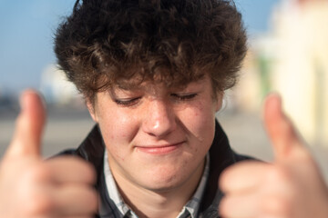 Young boy showing thumbs up