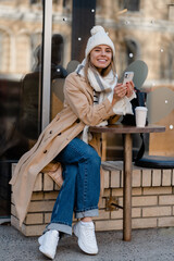 Wall Mural - stylish woman walking in winter street