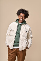 Wall Mural - Happy young African American gen z guy isolated on beige background. Smiling hipster ethnic teen student, cool curly ethnic teenager stylish fashion model standing laughing, vertical shot.