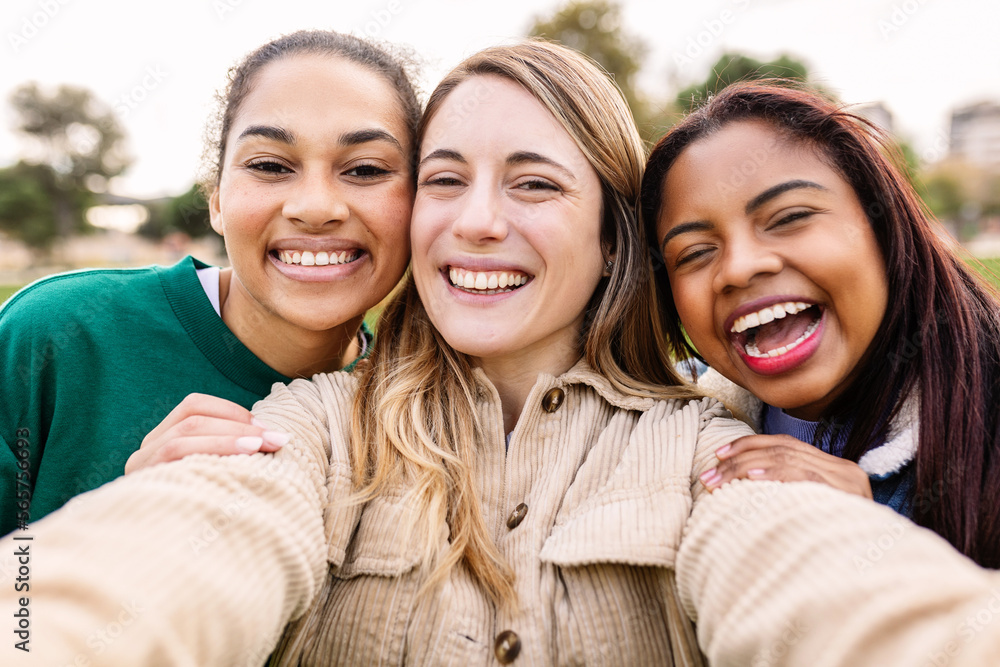 Young group of three diverse cheerful women taking selfie together ...