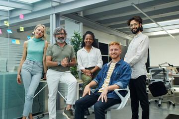 portrait of a team of multiracial professionals smiling confidently, young and mature colleagues loo