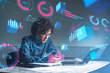 Businessman with phone and laptop on desk, metaverse hologram with statistics