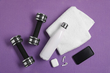 Sticker - Flat lay composition with stylish thermo bottle and dumbbells on purple textured background