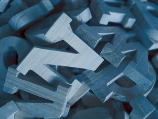 A closeup photograph of a variety of different typefaces in wooden letterpress