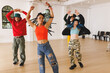 © Wavebreak Media - Image of group of group of diverse female and male hip hop dancers practicing in dance studio
