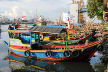 Portrait Of Traditional Fishing Boats That Lean On The Dock Beside The Largest Container Port In Indonesia