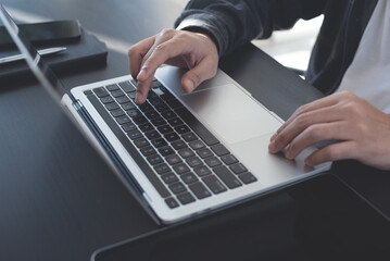 Wall Mural - Close up of man hands working, typing on laptop computer, browsing the internet, networking at home office, online working, freelancer at work, telecommuting concept