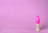 Fototapeta Lawenda - Pink egg with rabbit ears on the podium in the form of a column on a pink background