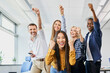 © baranq - Portrait of diverse group of colleagues cheering together in office