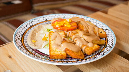 African combo plate with rice, fried cheese, grilled vegetables, peanut sauce and other traditional products.